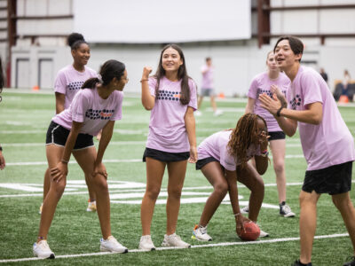 Group of First Tee participants playing football at the Atlanta Falcons field