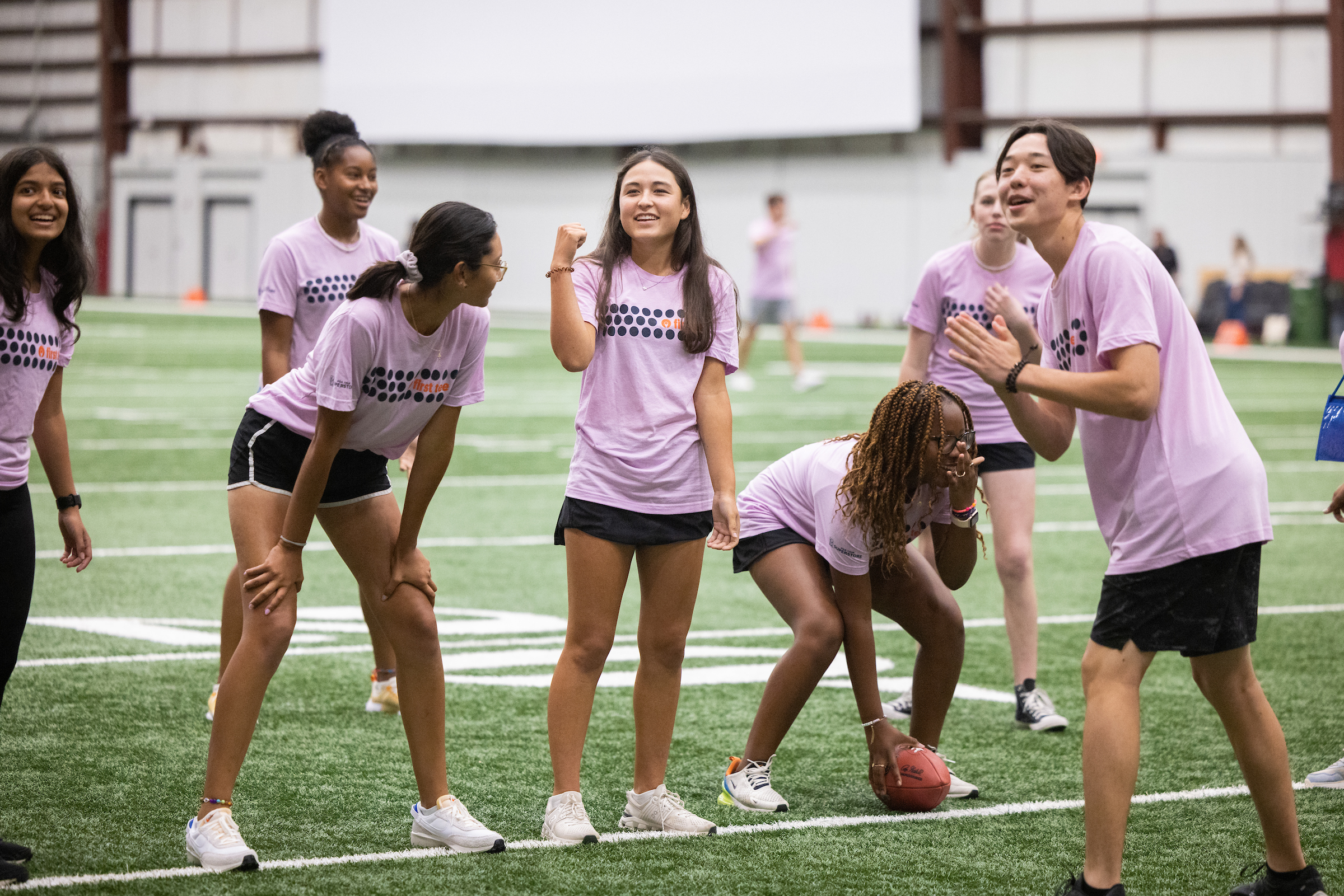 Group of First Tee participants playing football at the Atlanta Falcons field