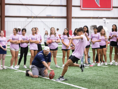 Group of First Tee participants playing football at the Atlanta Falcons field.