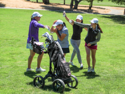 Group of girls throw water on the 2023 National Championship girls division winner, Megan Meng, in celebration.