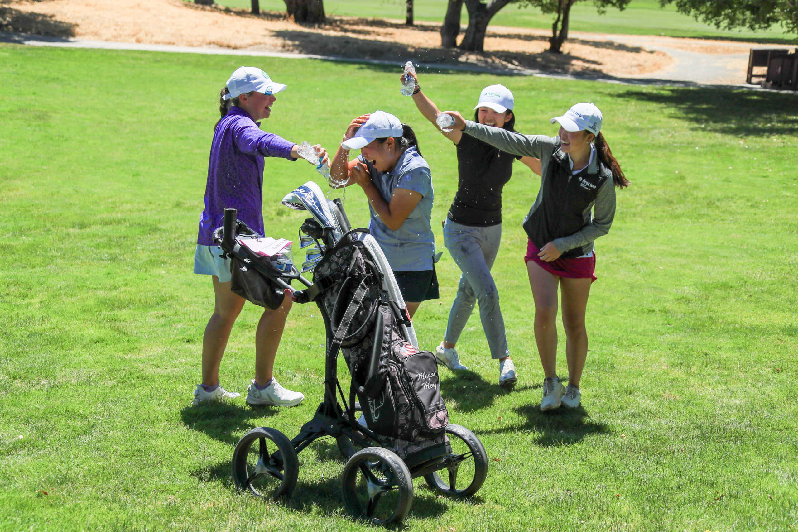 Group of girls throw water on the 2023 National Championship girls division winner, Megan Meng, in celebration.