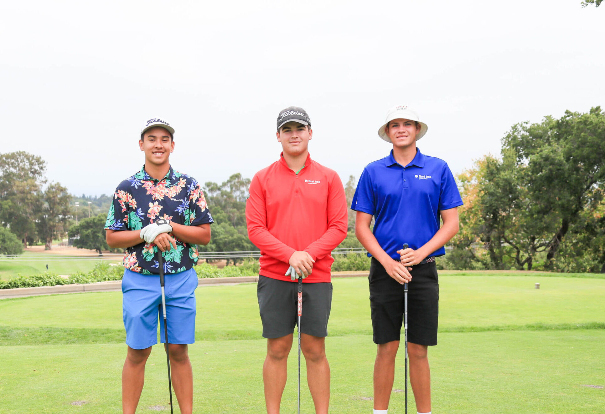Group of three boys standing on a tee box at 2023 First Tee National Championship.
