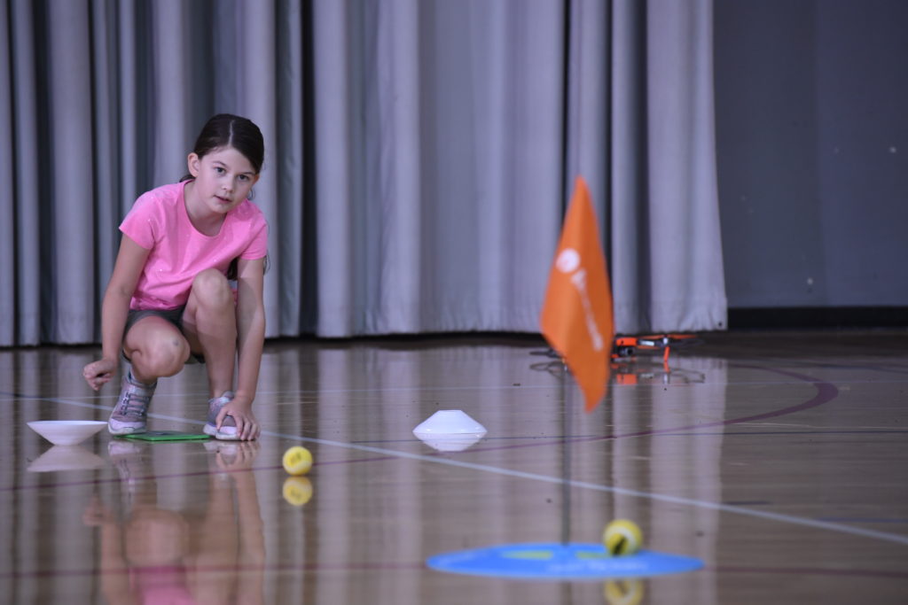 Participant playing a golf game in a gym.