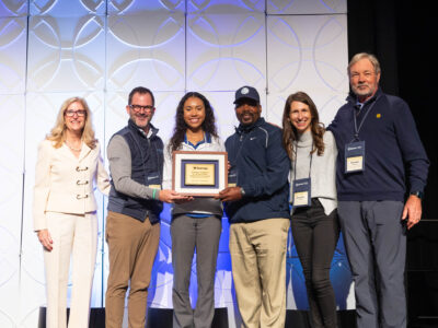 Group posing for an award.