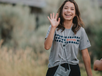 First Tee participant waving.